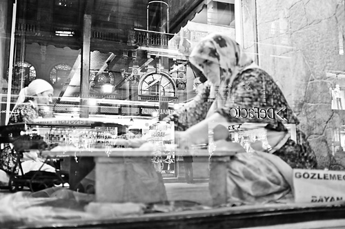 Women preparing food in a window Women preparing food in a window
